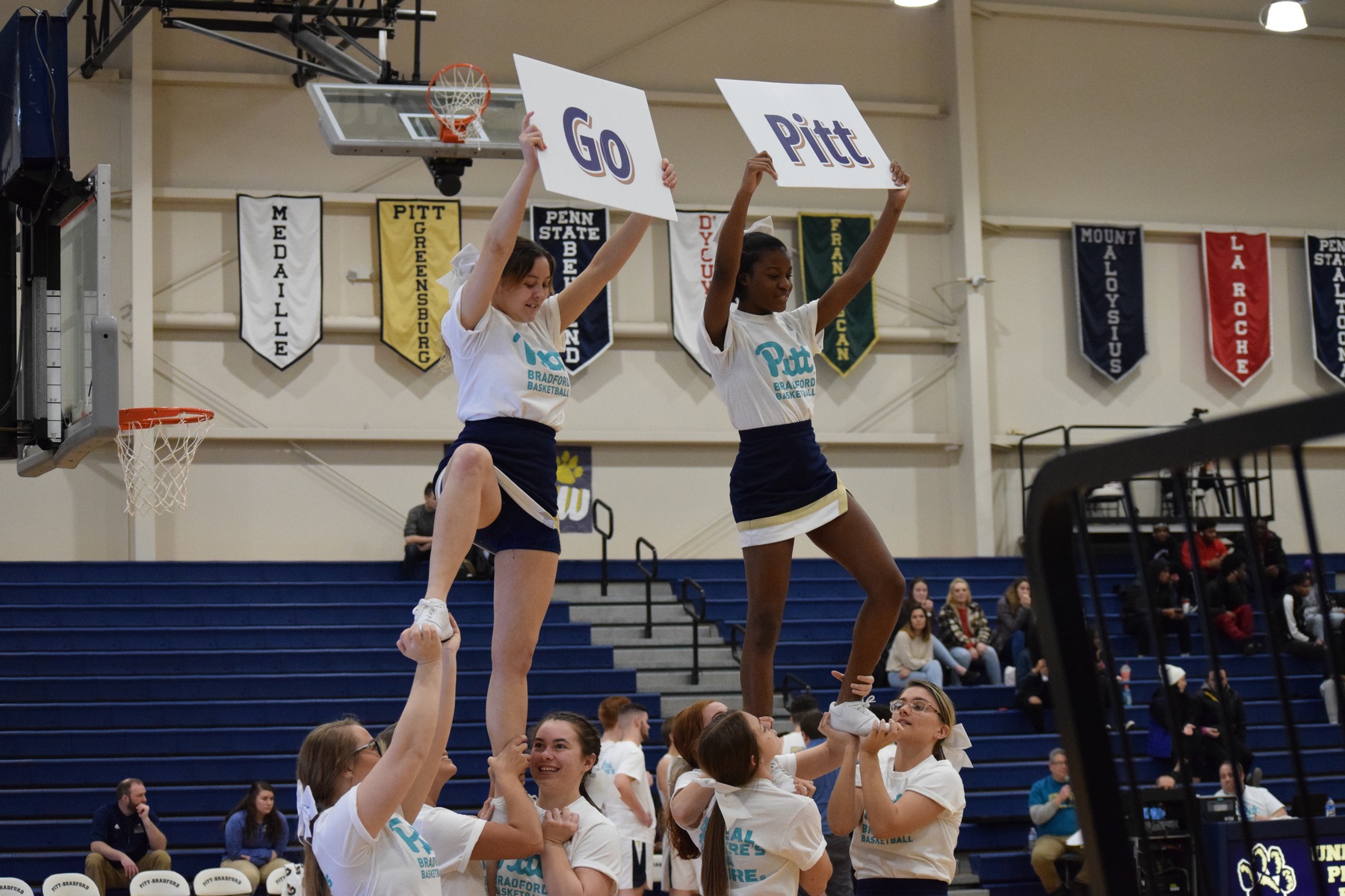 Pitt-Bradford Cheeleaders Perform a Routine at a Basketball Game